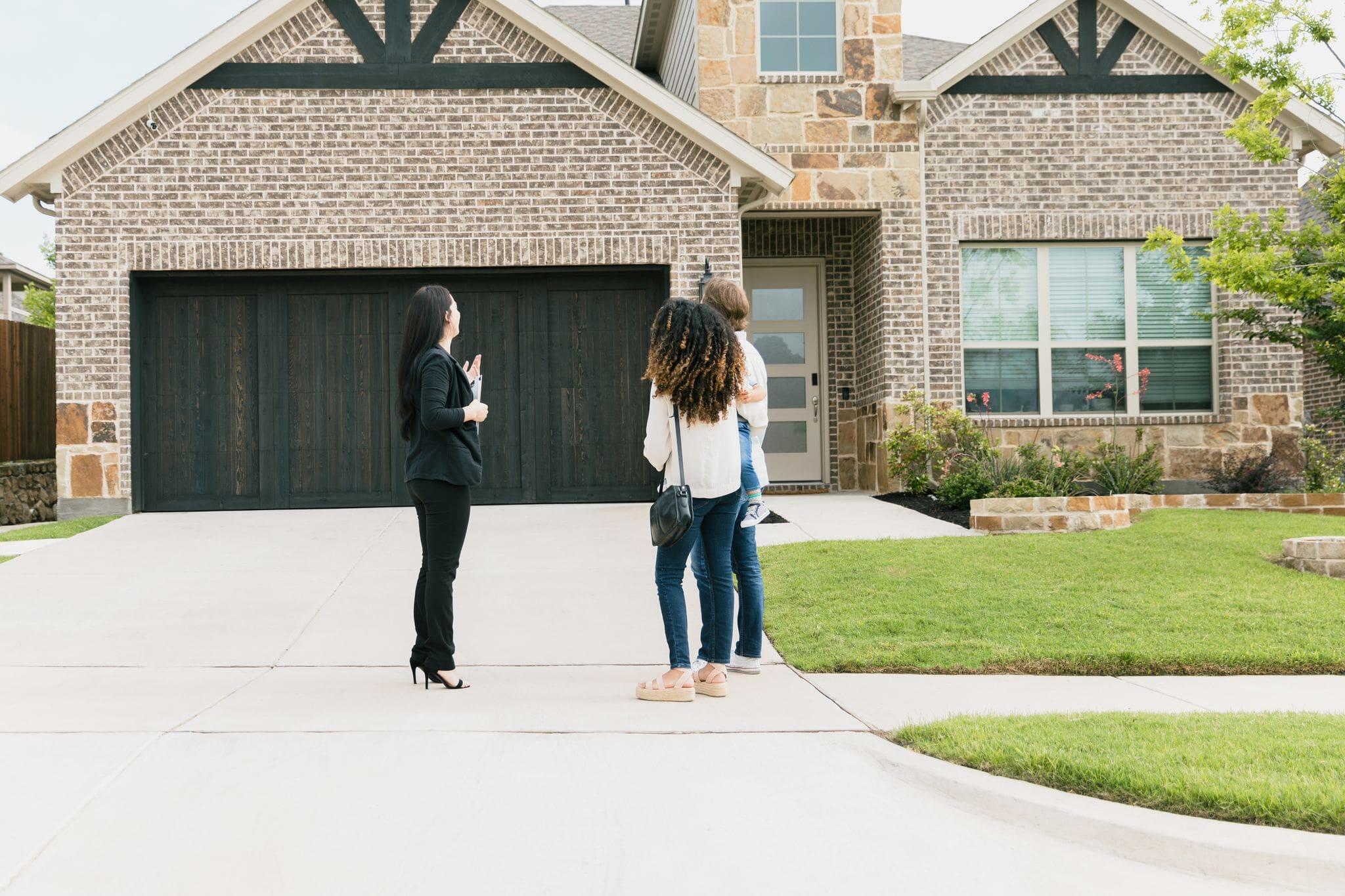 real estate agent showing a home to an interested couple