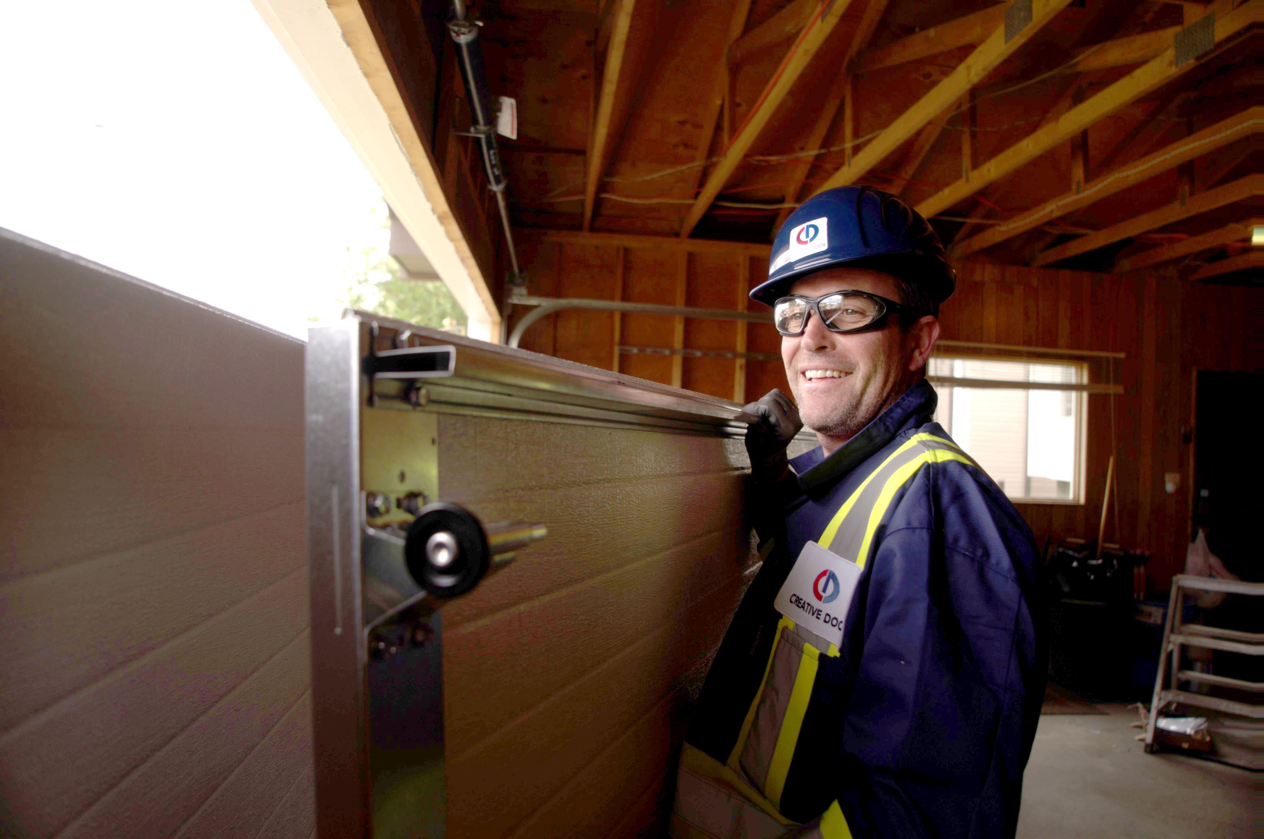 creative door professional technician installing a garage door