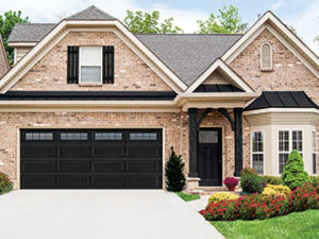 Brick house with black garage door Brick house with black garage door