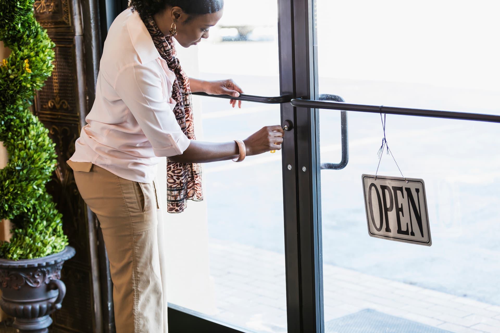 shop owner unlocking pedestrian entrance door
