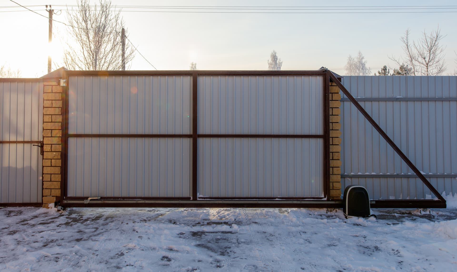 sliding gate in winter with snow on ground