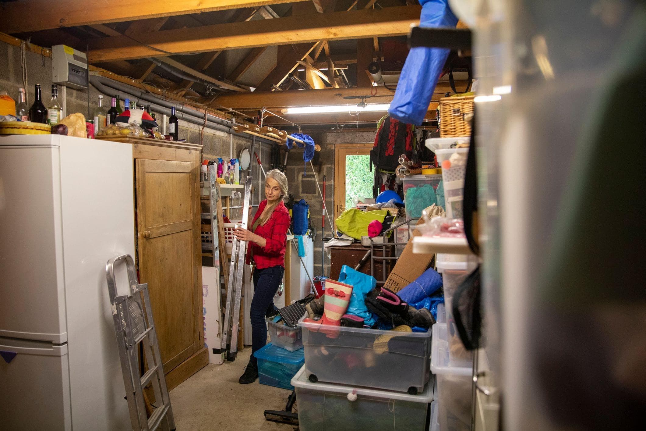 woman cleaning and decluttering her suburban garage