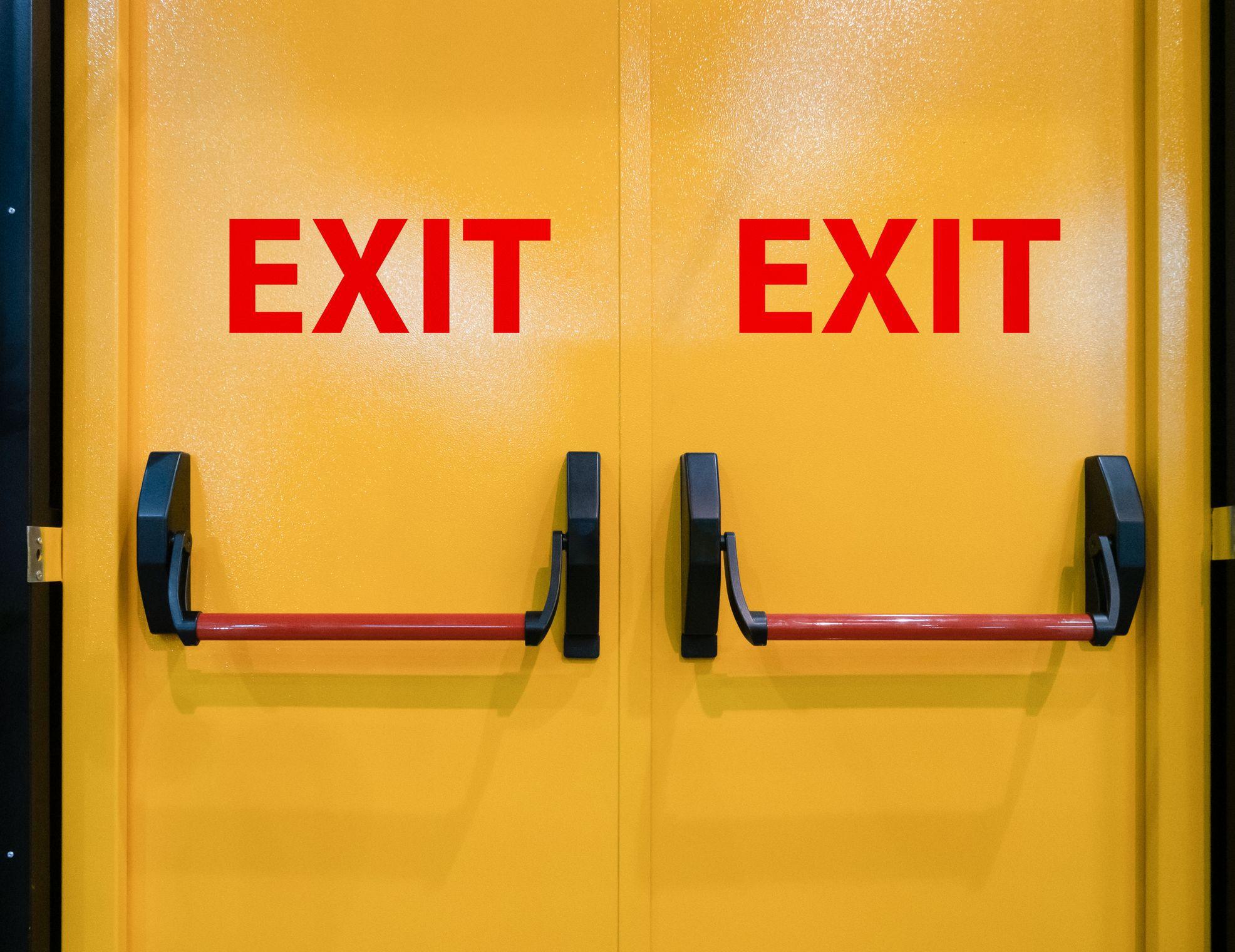 bright yellow exit doors with red lettering bright yellow exit doors with red lettering