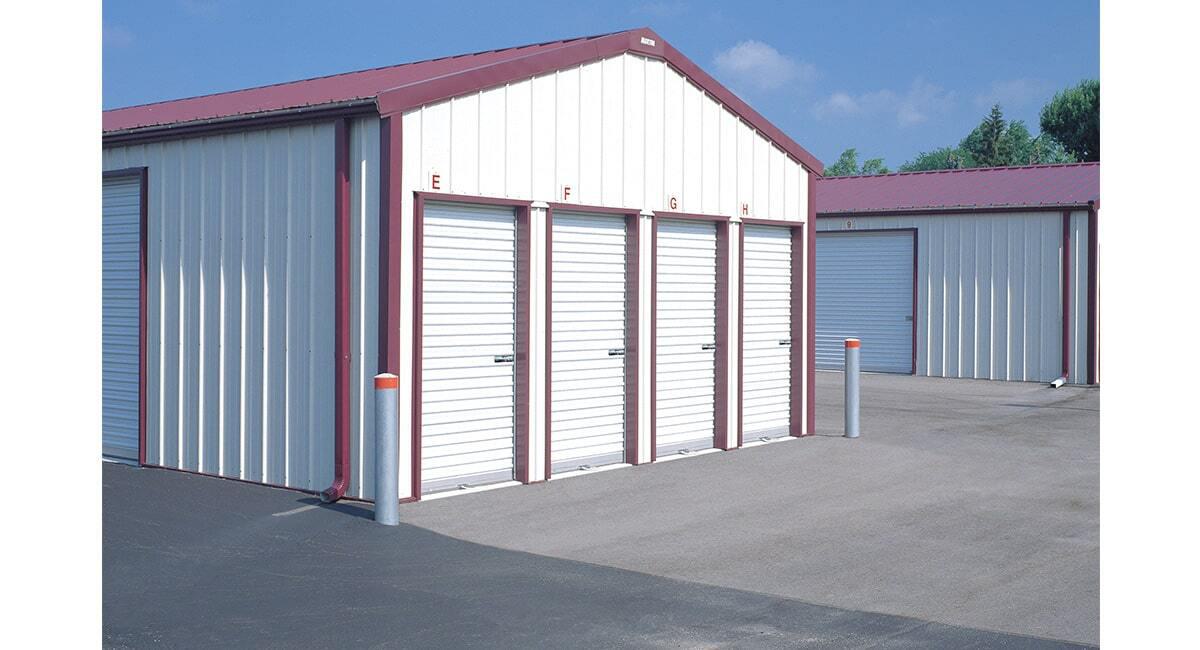exterior of storage unit facility with several white wayne dalton rolling doors
