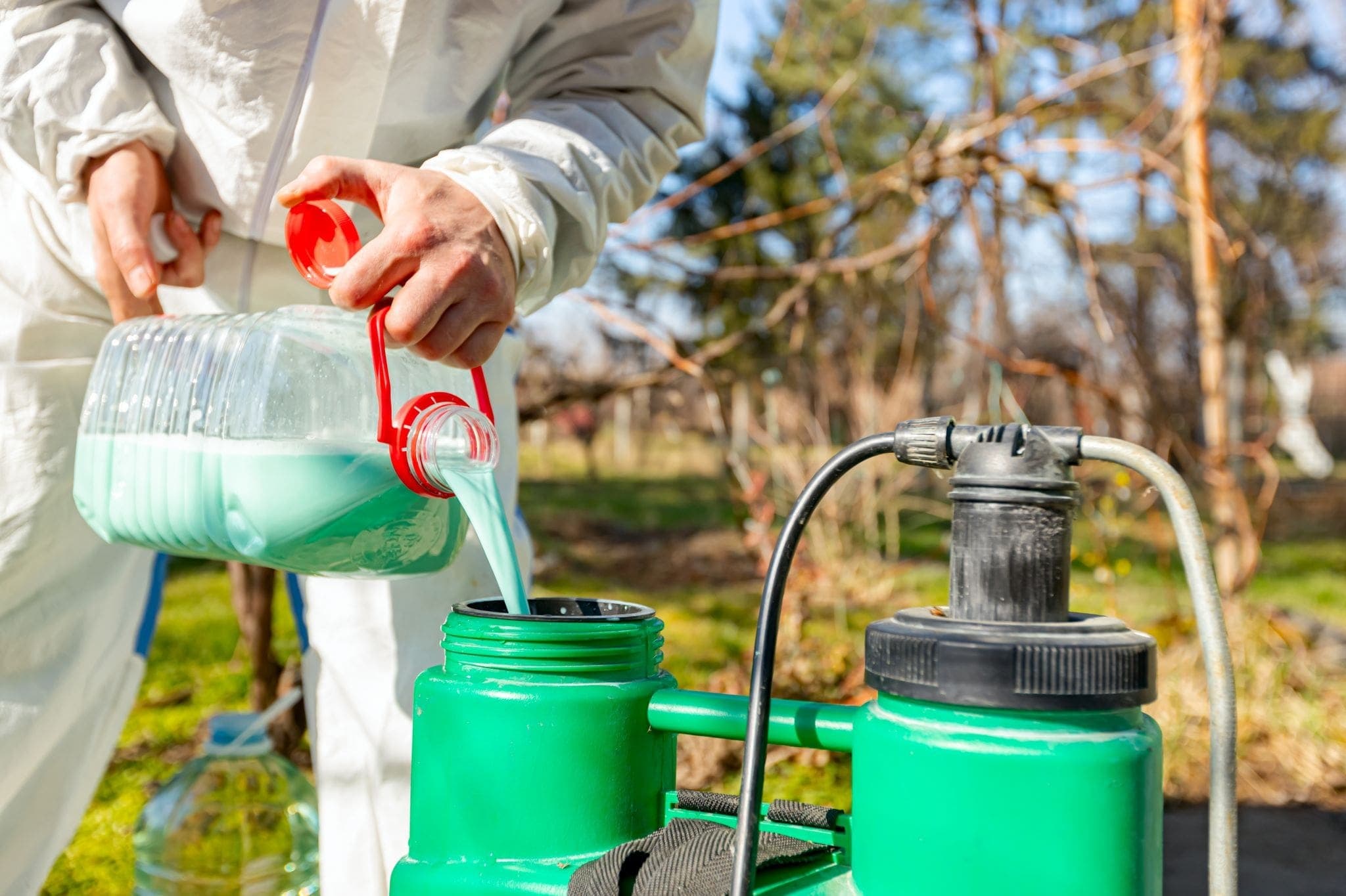 pouring leftover pesticides into storage containers