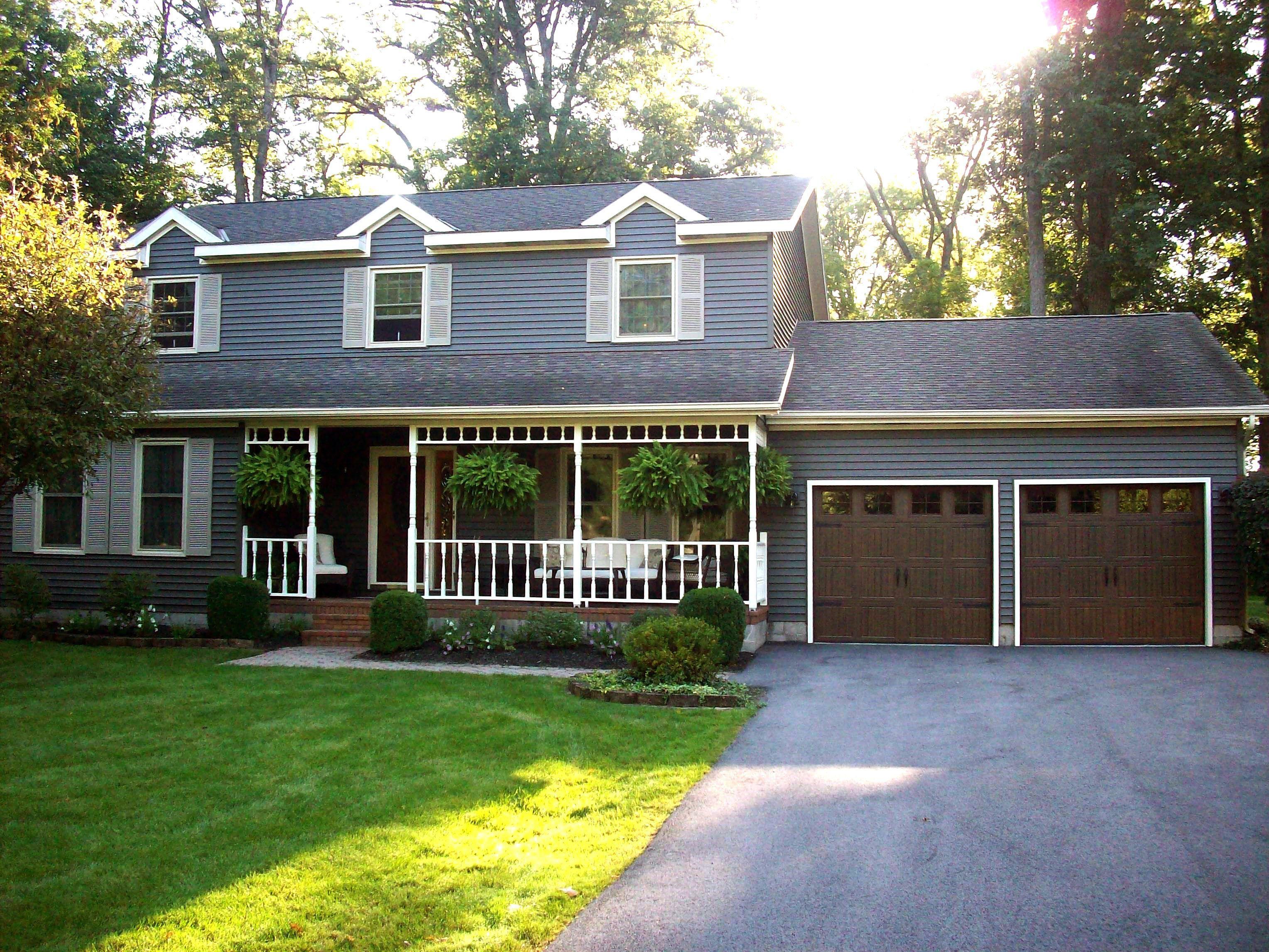 front of home with wayne dalton garage door on a summer evening