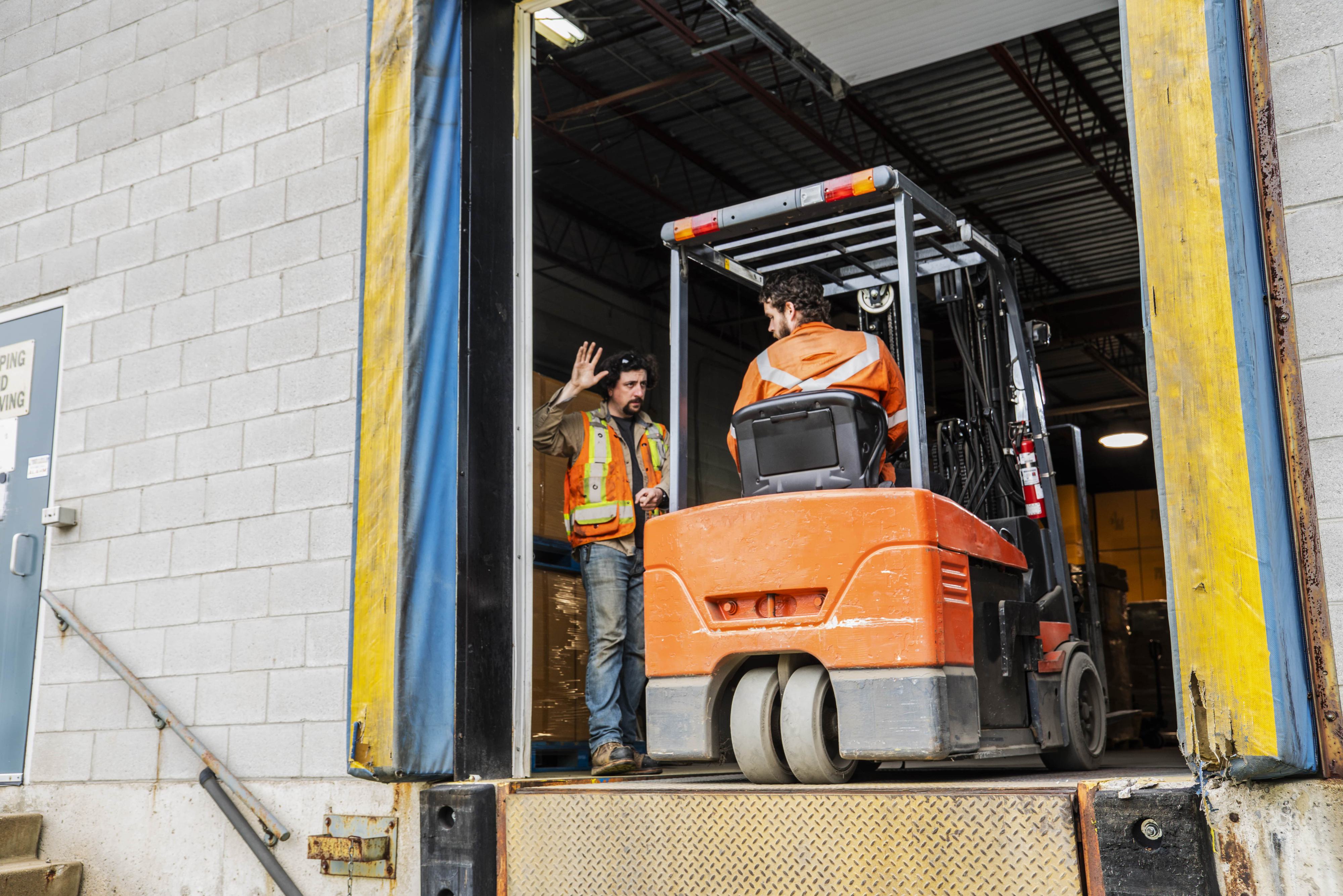 forklift driver and supervisor at loading dock