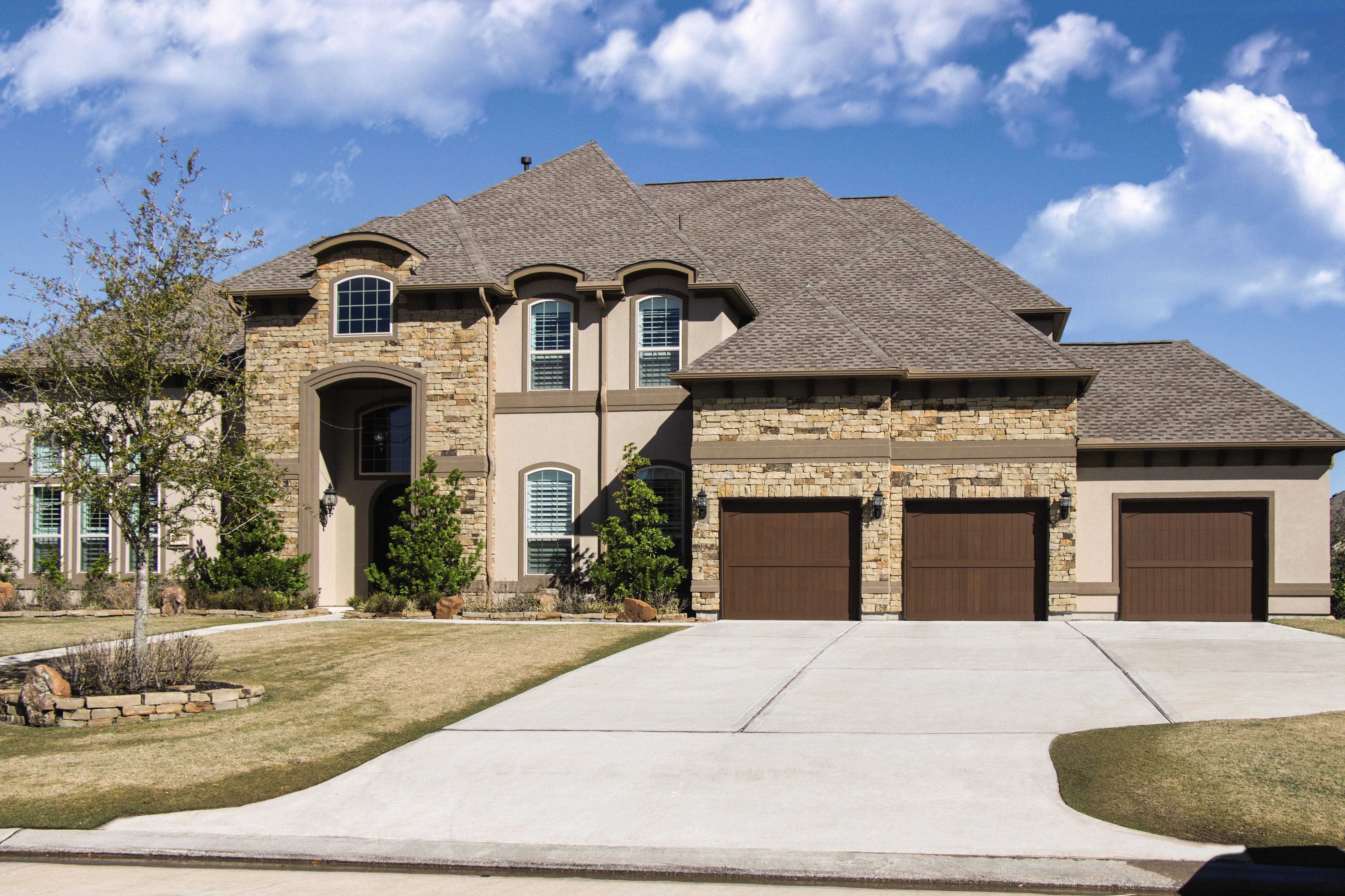 Wayne Dalton Custom Wood Garage Doors on a sunny day Wayne Dalton Custom Wood Garage Doors on a sunny day