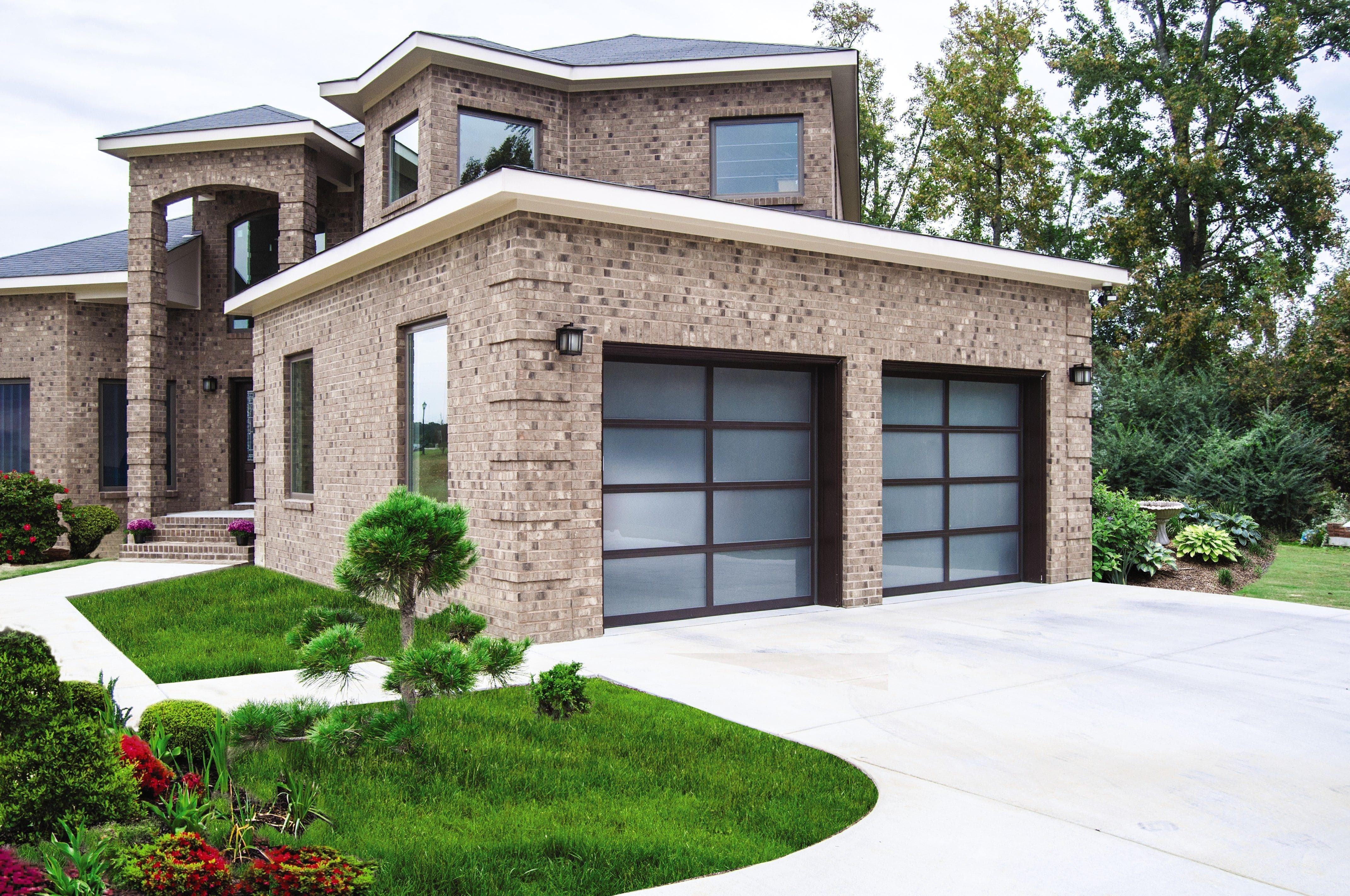 beautiful home with aluminum and frosted glass double garage doors