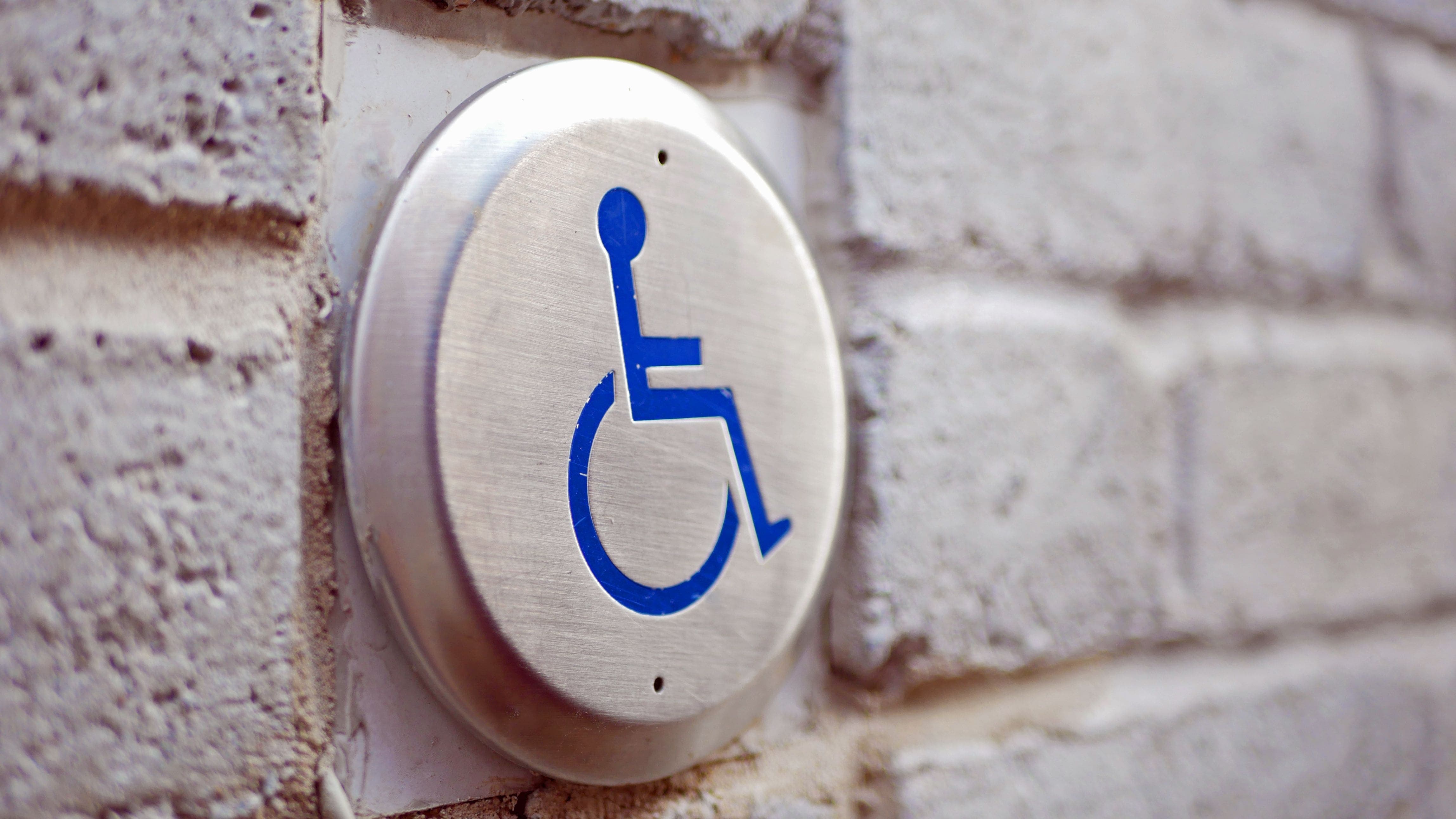 Wheelchair accessibility assistance button beside pedestrian door