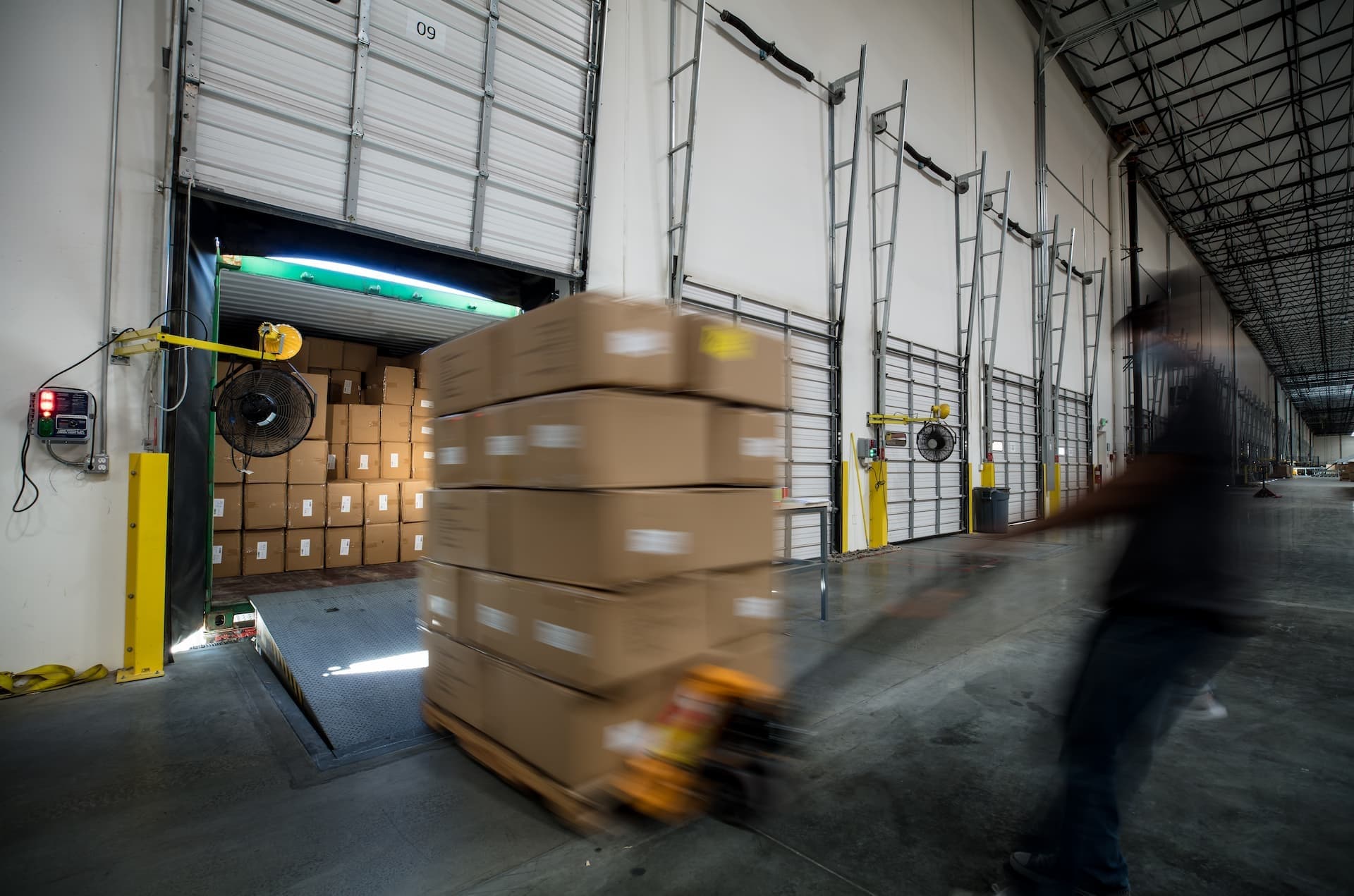 workers unloading boxes from truck at warehouse