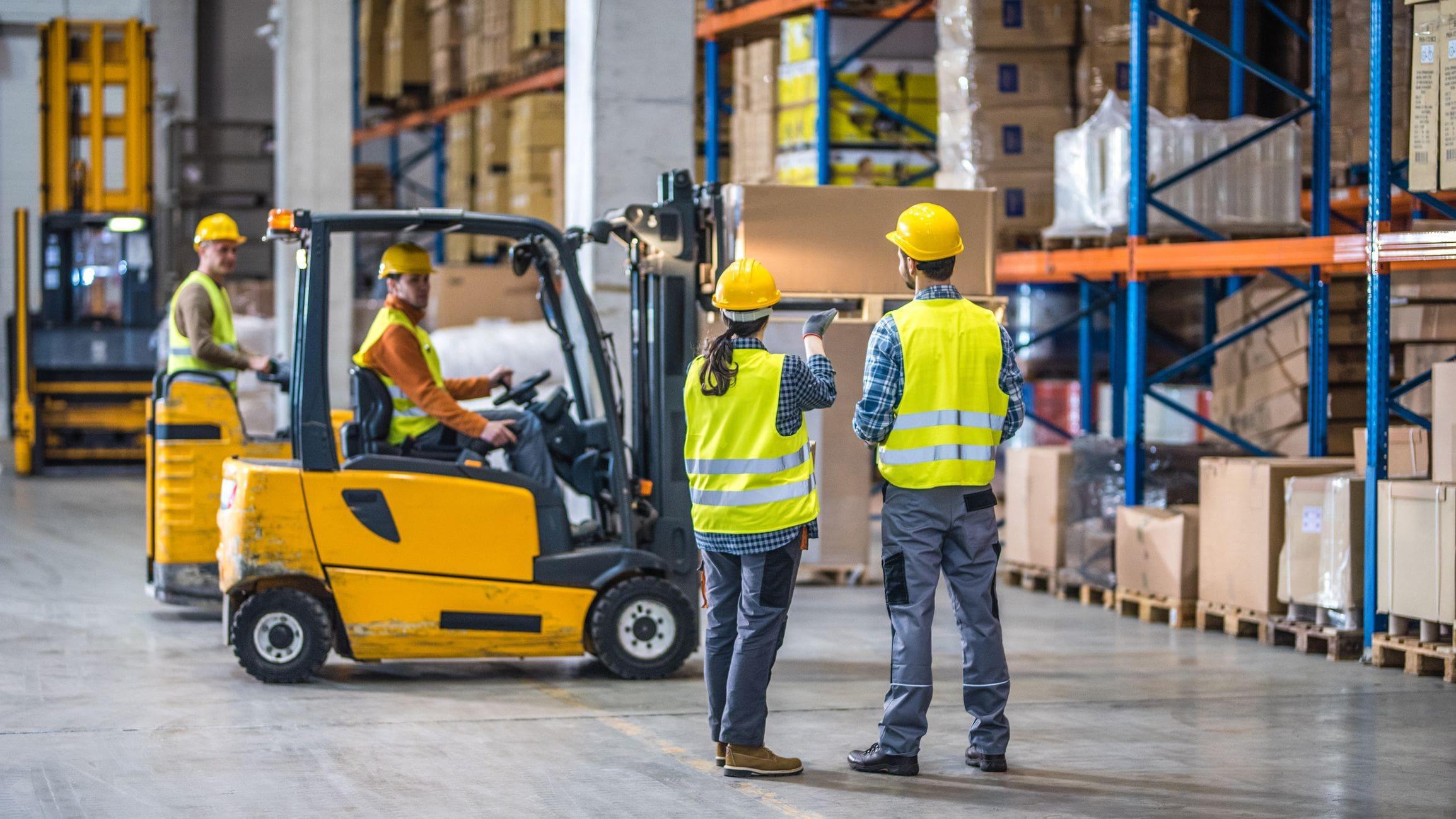 workers using loud equipment in a warehouse workers using loud equipment in a warehouse