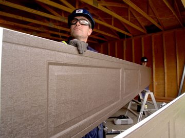 CDS technician installing a new garage door panel