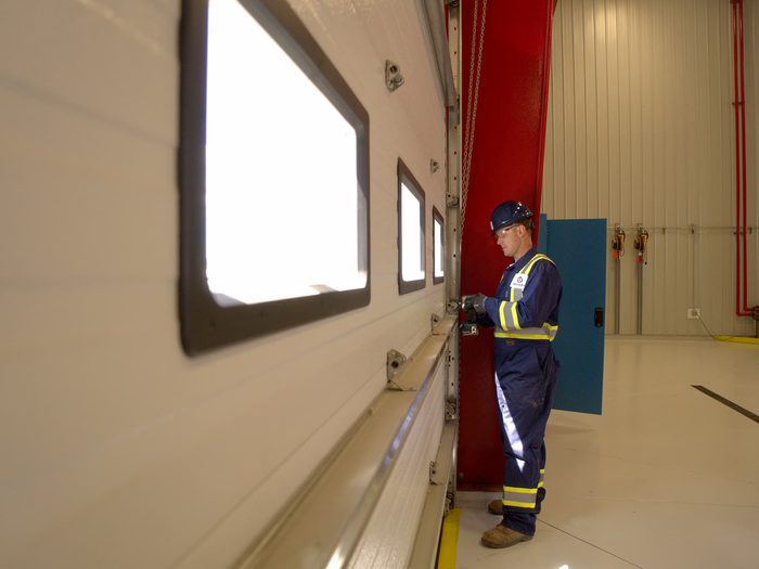 CDS technician maintaining commercial sectional door