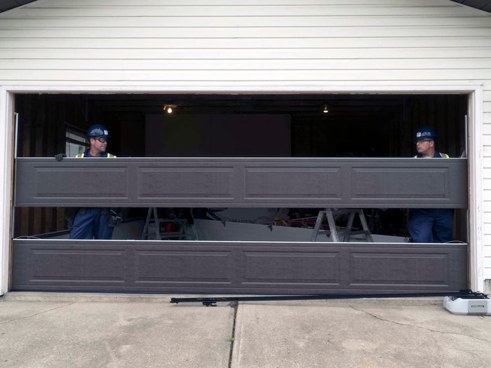 CDS technicians holding garage door panel