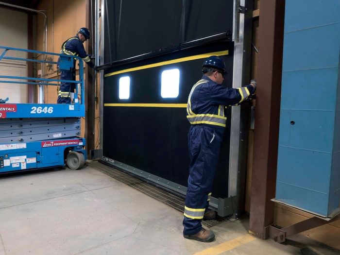 CDS technicians maintaining commercial door tracks