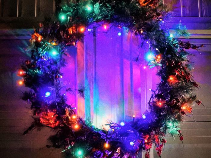 Christmas Wreath With Lights Hanging On A Garage Door