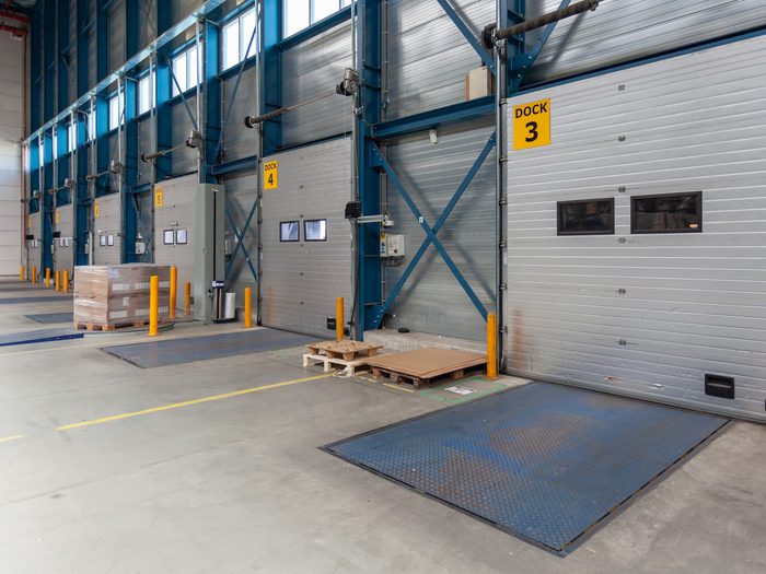 Numbered loading docks in a warehouse with mechanical pit levelers