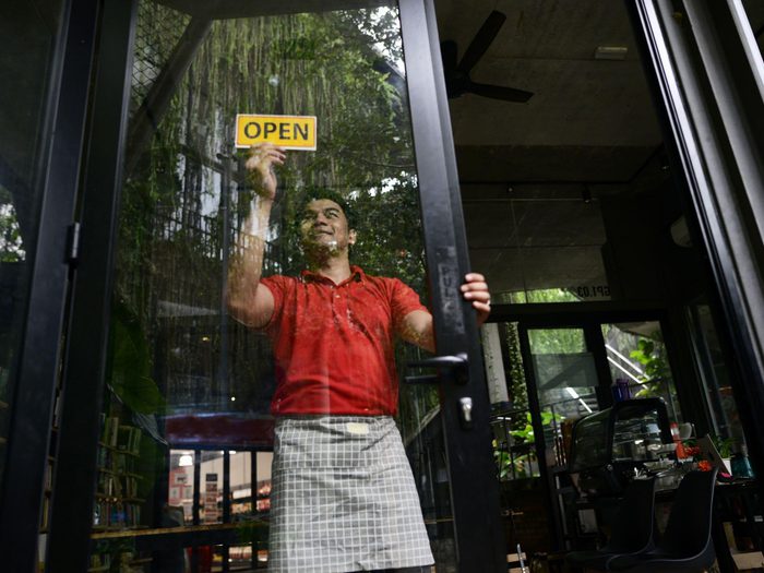 Small Business Cafe Owner At Entrance Min