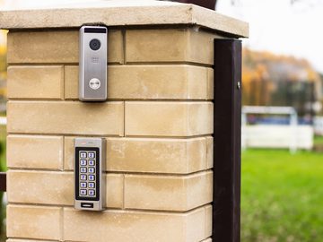 Video intercom and keypad gate access system installed on brick post for secure entry control