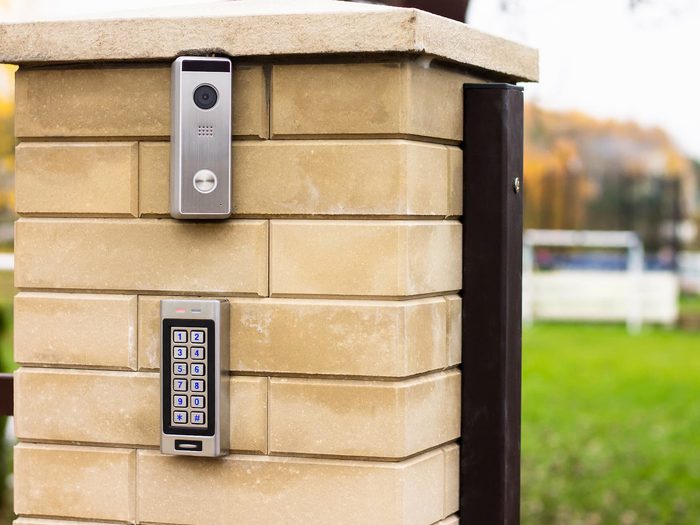Video intercom and keypad gate access system installed on brick post for secure entry control