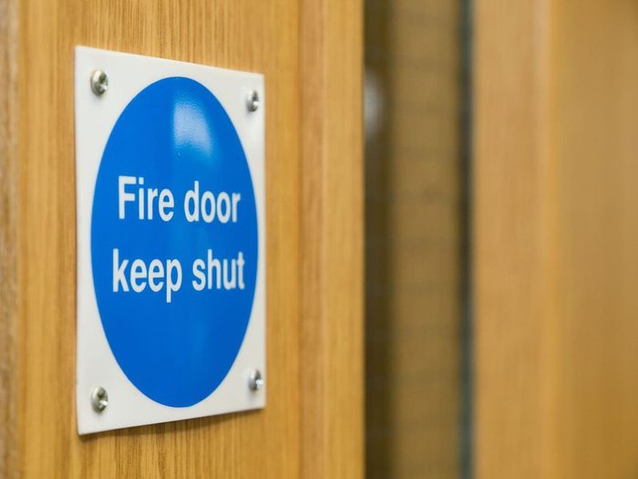 Blue fire door sign min