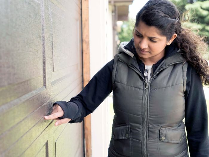 Homeowner inspecting garage door