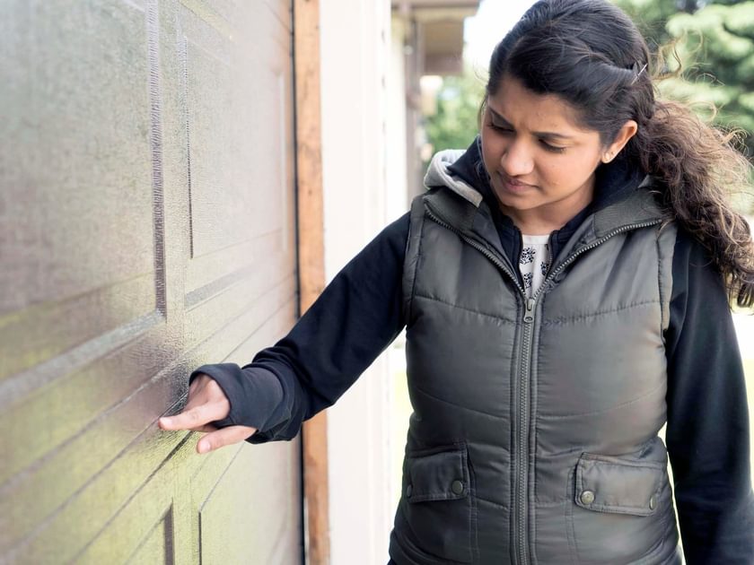 Homeowner inspecting garage door