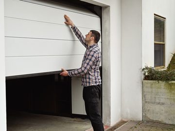 Homeowner opening garage door