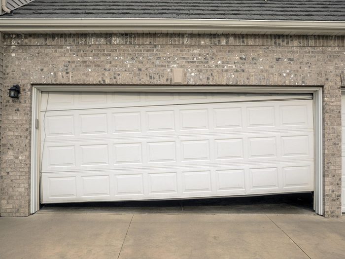 Misaligned white garage door