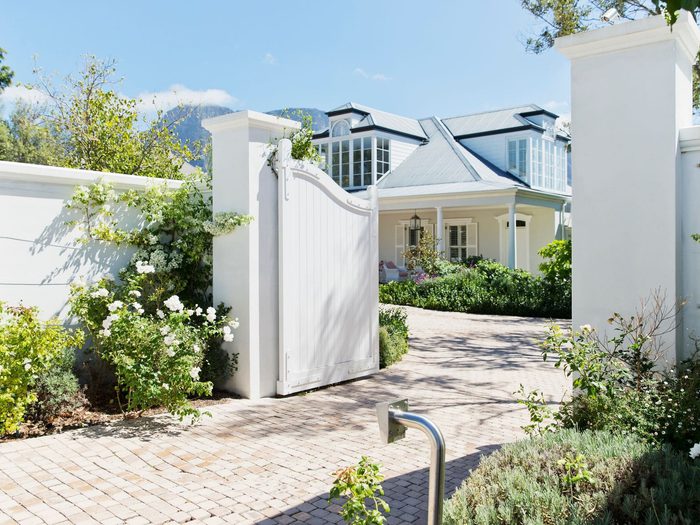 Modern white gate in bloom min