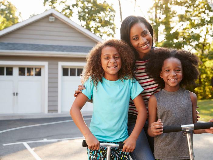 Mom With Kids In Driveway Min