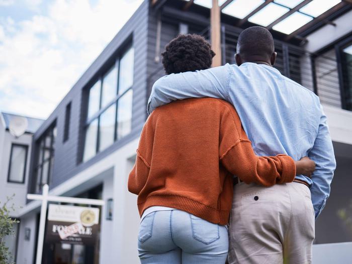 New Homeowners Looking Up At House Min