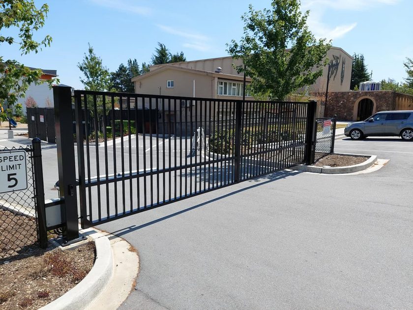 Swing gate for property parking lot entrance