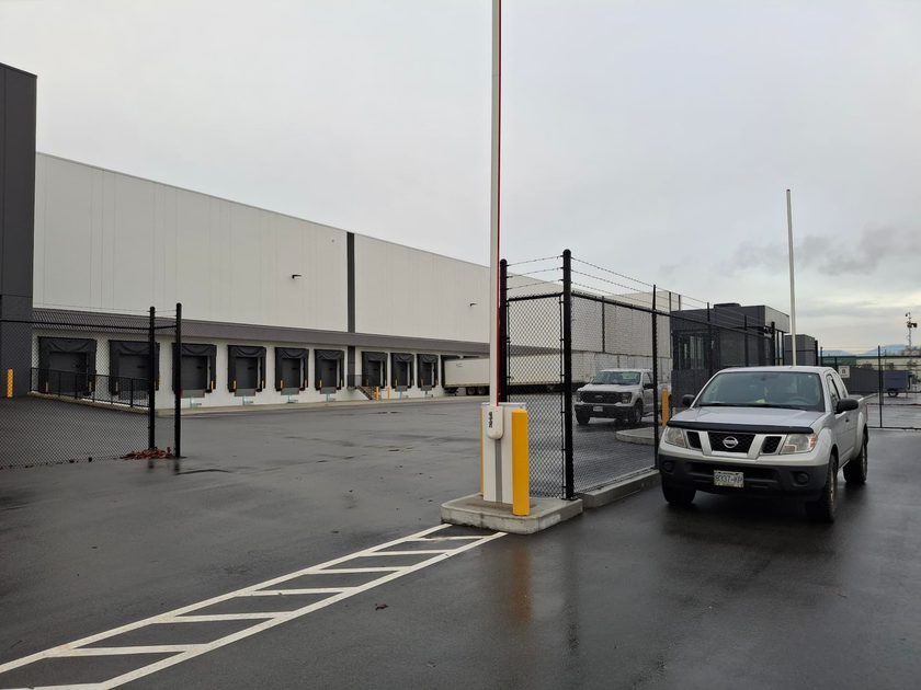 Warehouse with perimeter security gate